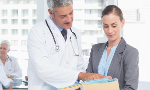 Nursing Leadership and Administration Banner Nursing Executive Reviewing Charts with Physician